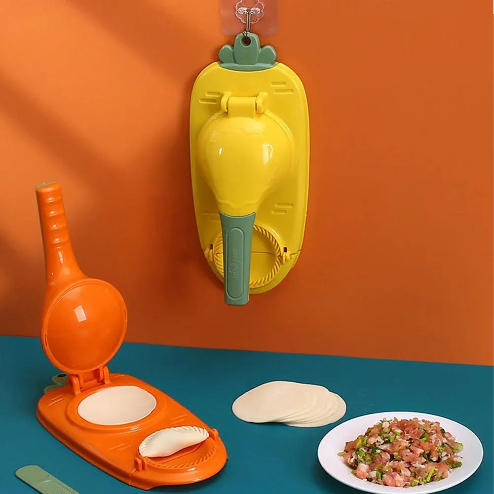Orange and white manual kitchen dumpling press tool with ergonomic handle on wooden table