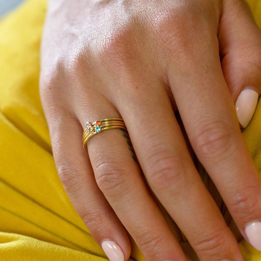 Geometric titanium steel ring with December birthstone colour and engraved gold lettering on band.