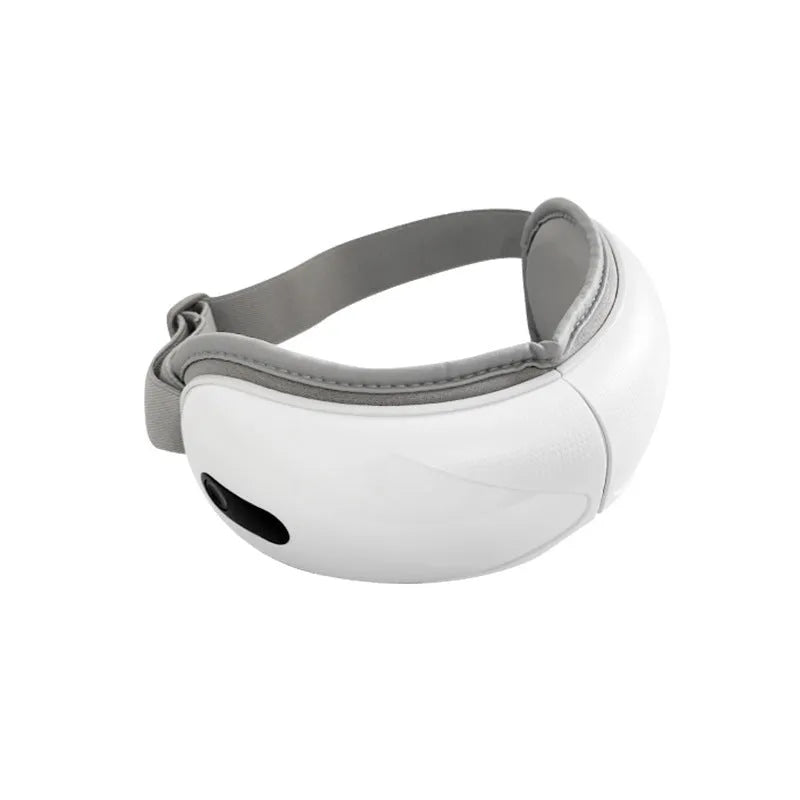 White rechargeable eye massager with airbag compression and hot compress functions on a plain background.