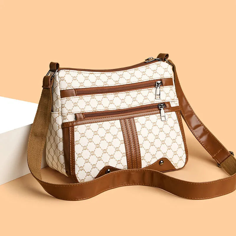 Brown women's crossbody bag with stitching pattern and adjustable shoulder strap.