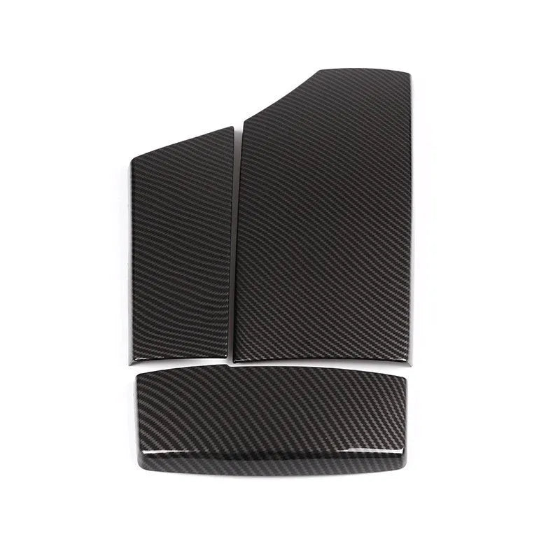 Set of three black ABS car armrest box protective covers with a diagonal carbon fibre weave pattern and shiny surface.