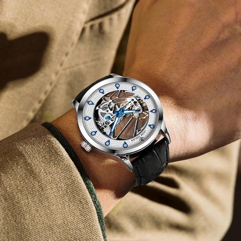 Silver men's mechanical watch with white dial, blue luminous hands, and a black leather strap.