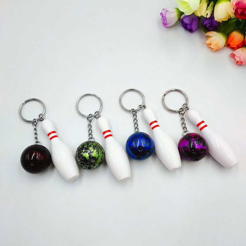 Mini simulation sports bowling ball keychain pendant in dark red, blue, purple, and green colours.