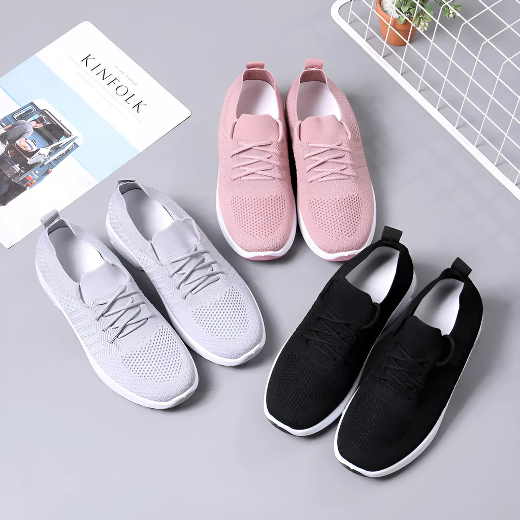 Women's black mesh lace-up sneakers with a round toe and non-slip sole on a white background.
