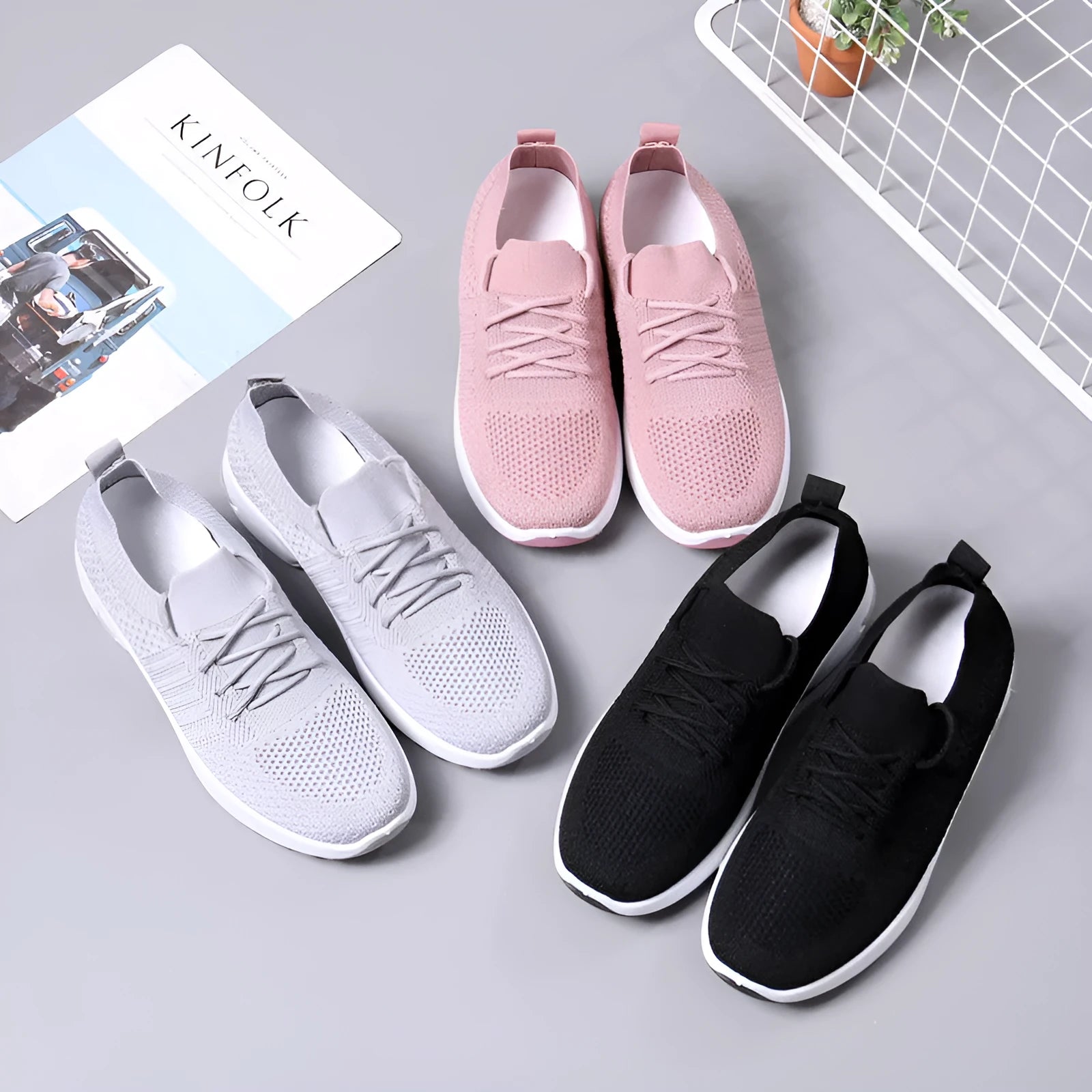 Women's black mesh lace-up sneakers with a round toe and non-slip sole on a white background.