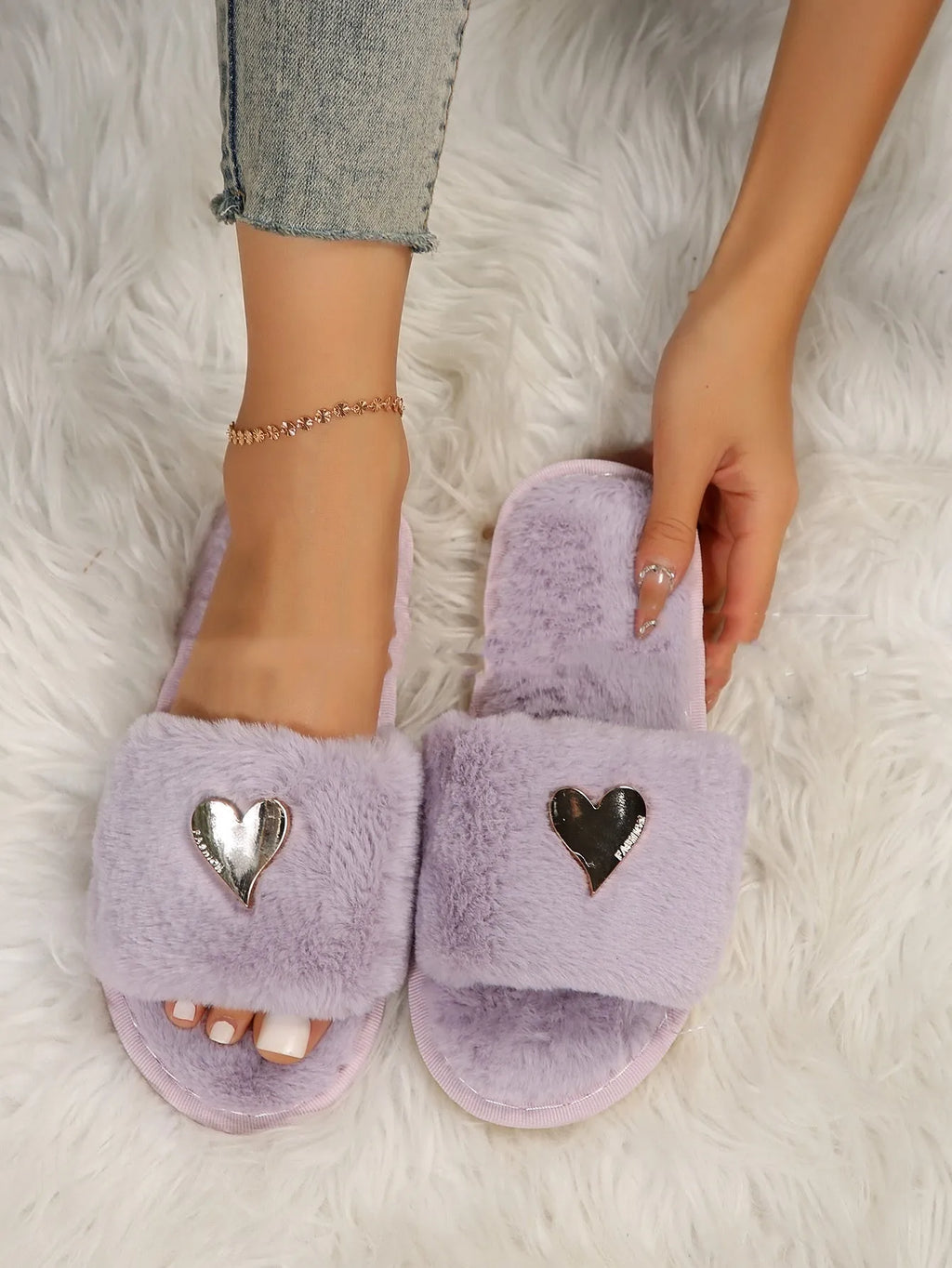 Warm faux fur slippers for women in beige with heart pendant detail and plastic sole