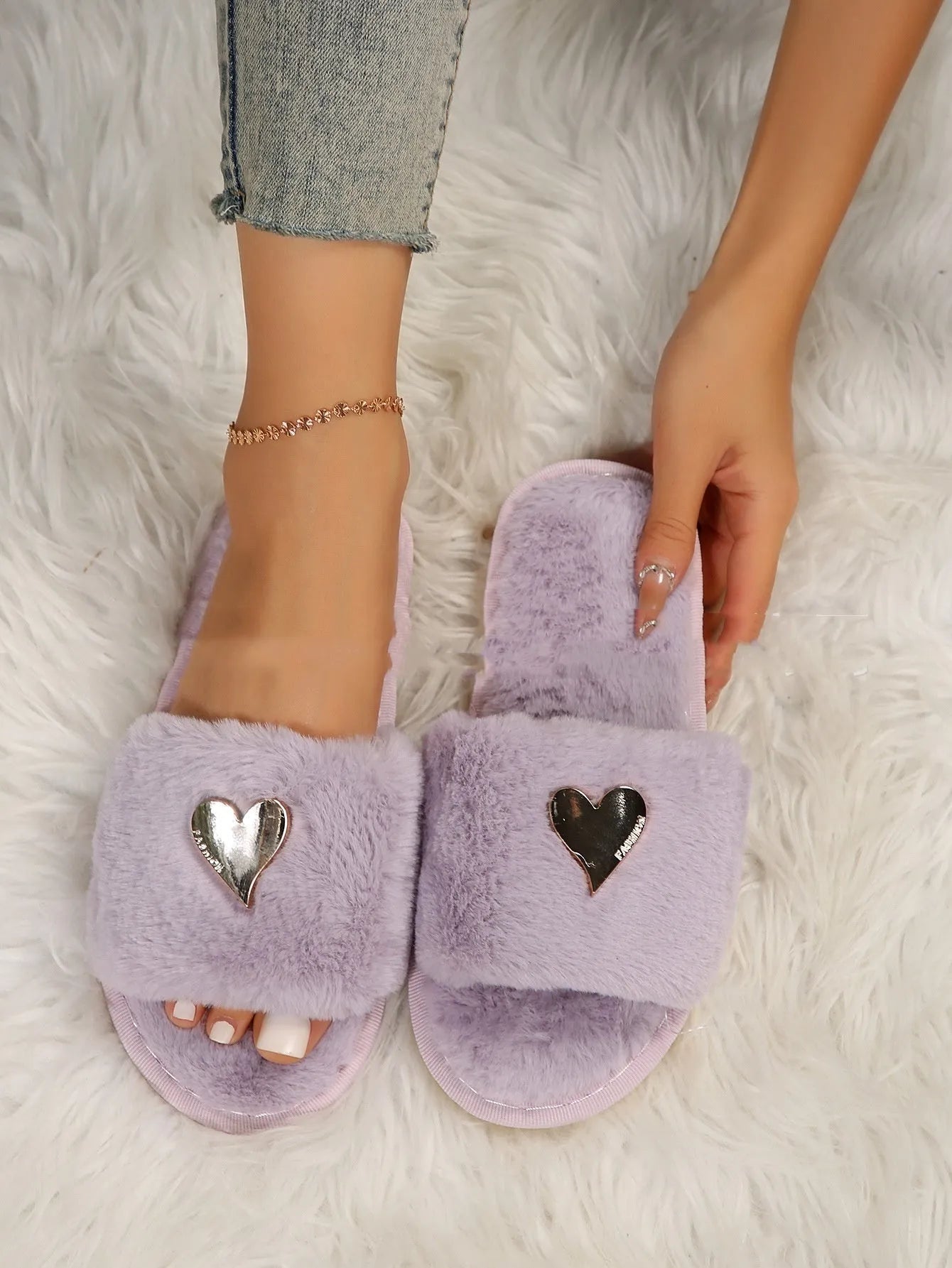 Warm faux fur slippers for women in beige with heart pendant detail and plastic sole