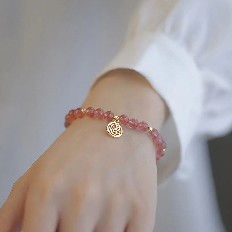 Women's strawberry quartz blessing card bracelet with glass construction and universal wrist size
