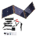 Black foldable portable solar panel unfolded showing three solar cell sections, with battery clips and car charger accessories