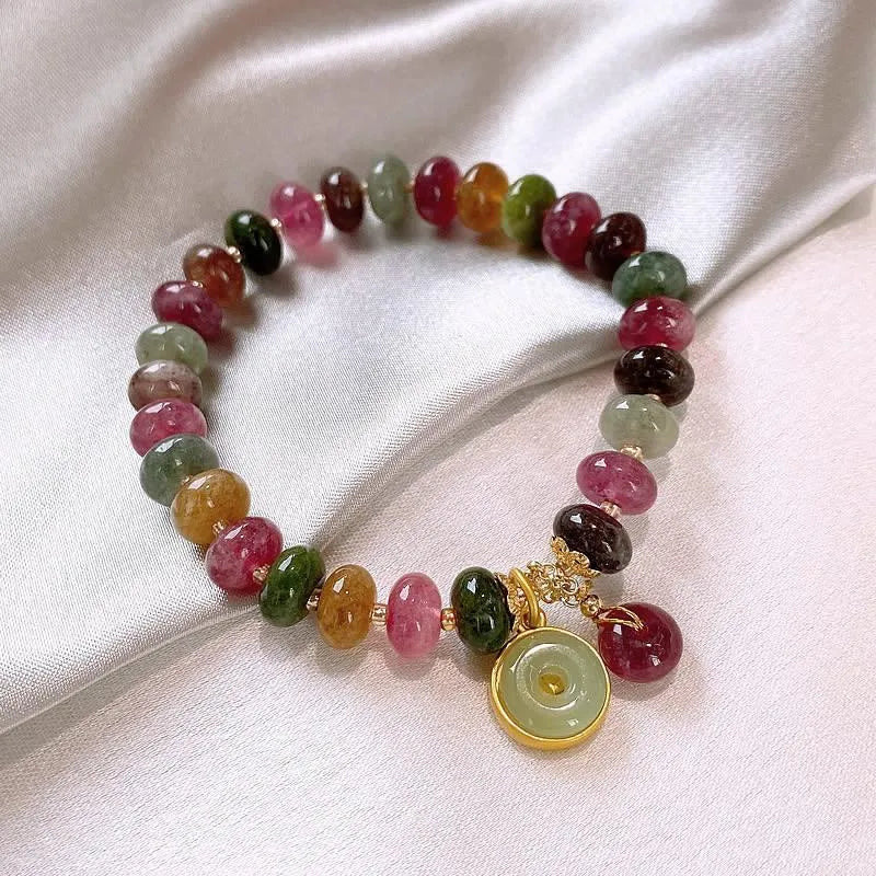 Colourful tourmaline bracelet with rabbit pendant and round abacus beads on wrist