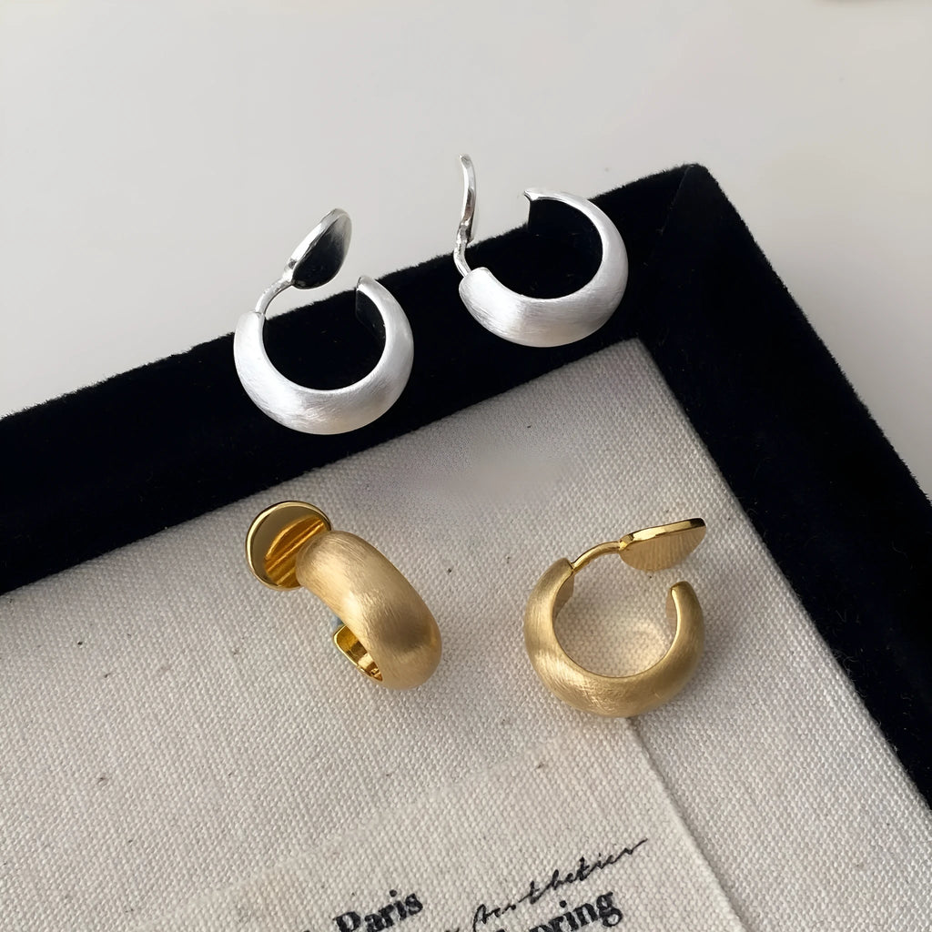 Geometric C-shaped frosted brushed copper earrings in gold as ear clips for women minimalist style