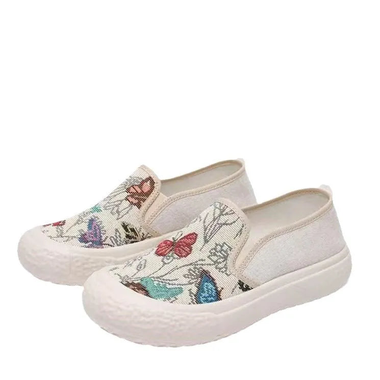 Women's black and white slip-on canvas shoes with round toes and plastic soles