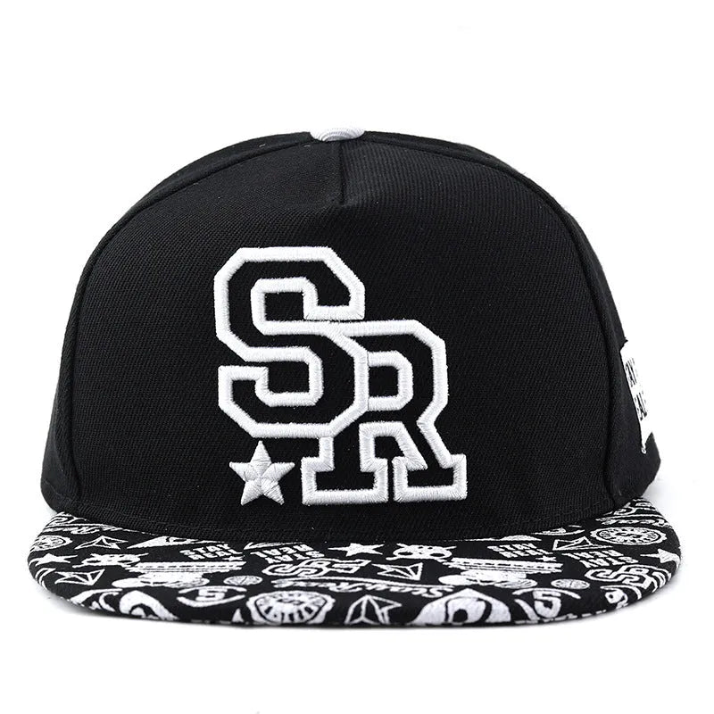 A black cotton baseball cap with embroidered lettering on the front, showing the adjustable strap at the back.