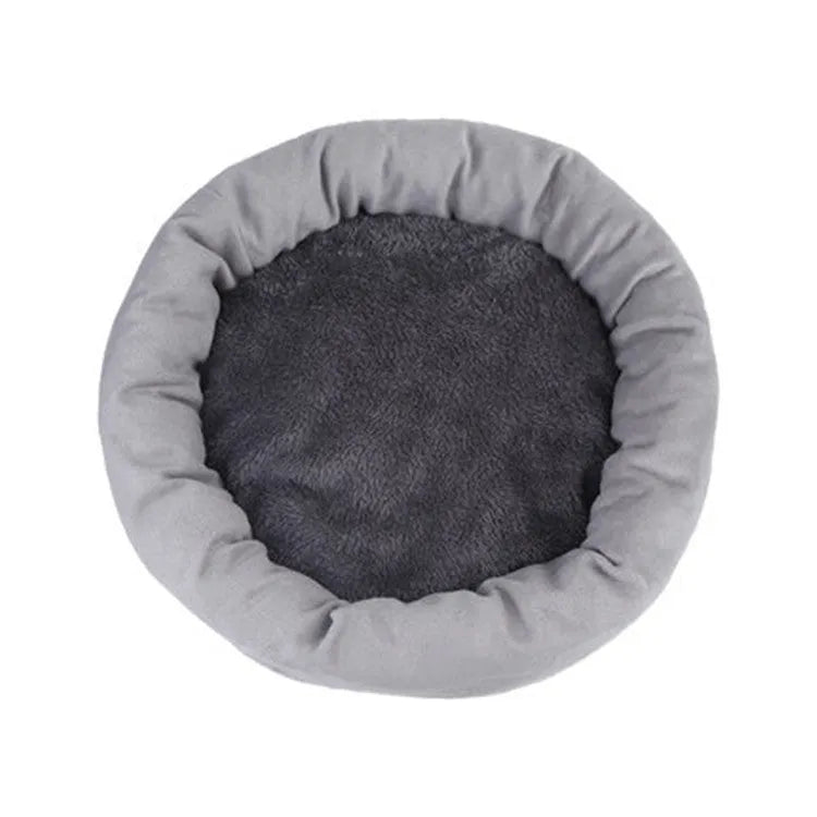 Soft light grey cotton-filled dog bed for a small dog, showing cloth material and round shape.