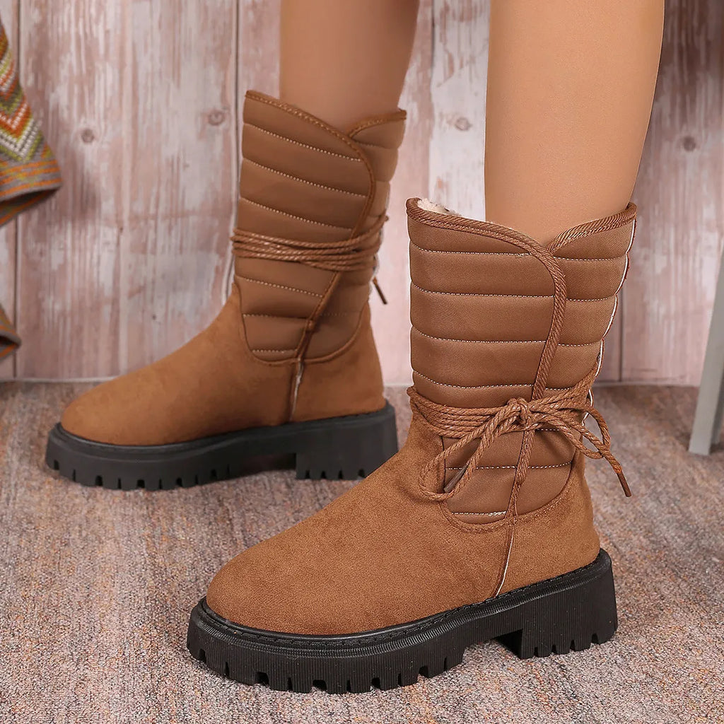 Women's black suede high-top winter boots with a chunky heel and lace-up front, fleece-lined.