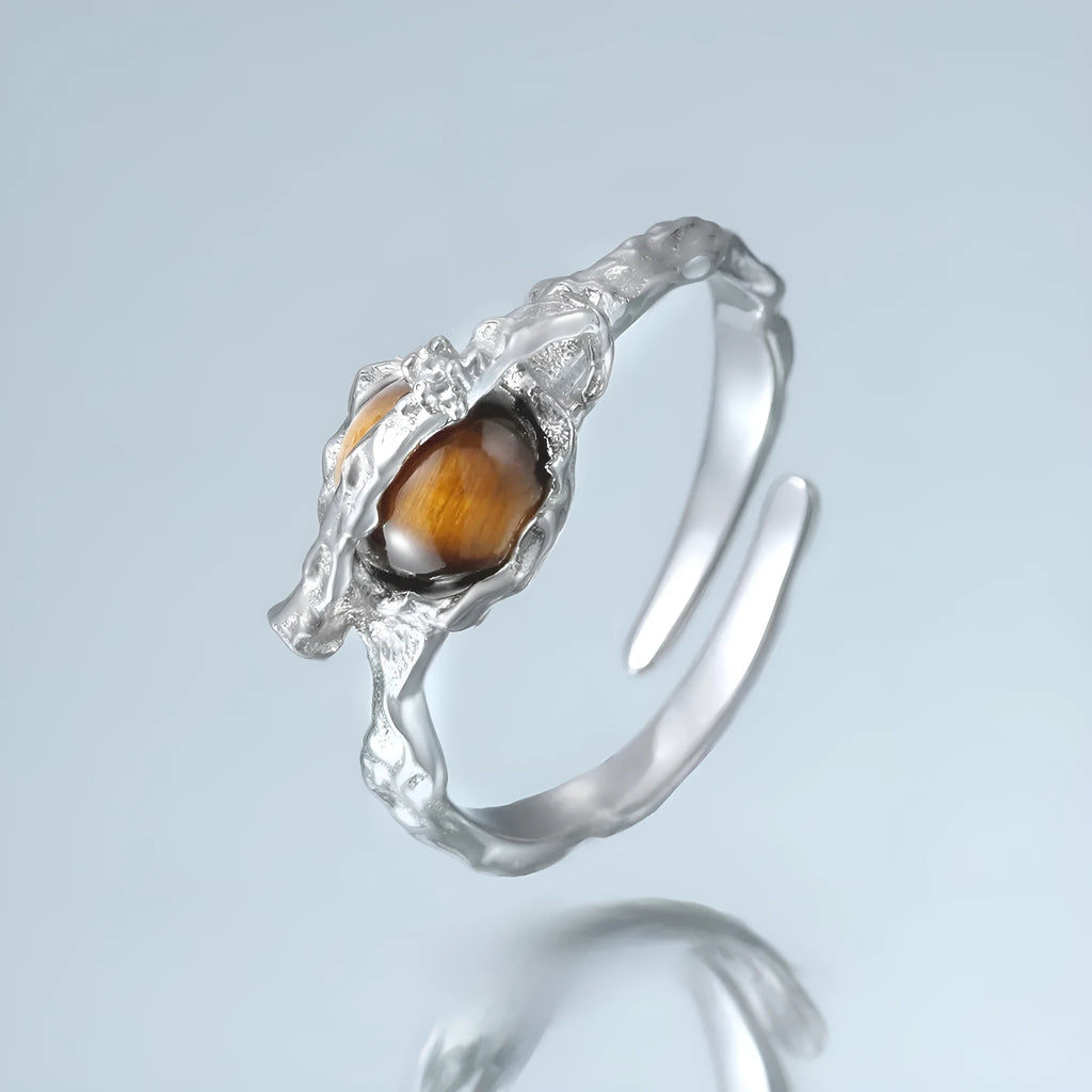 Saturn design adjustable silver ring with white gold electroplated finish and tigereye open pattern