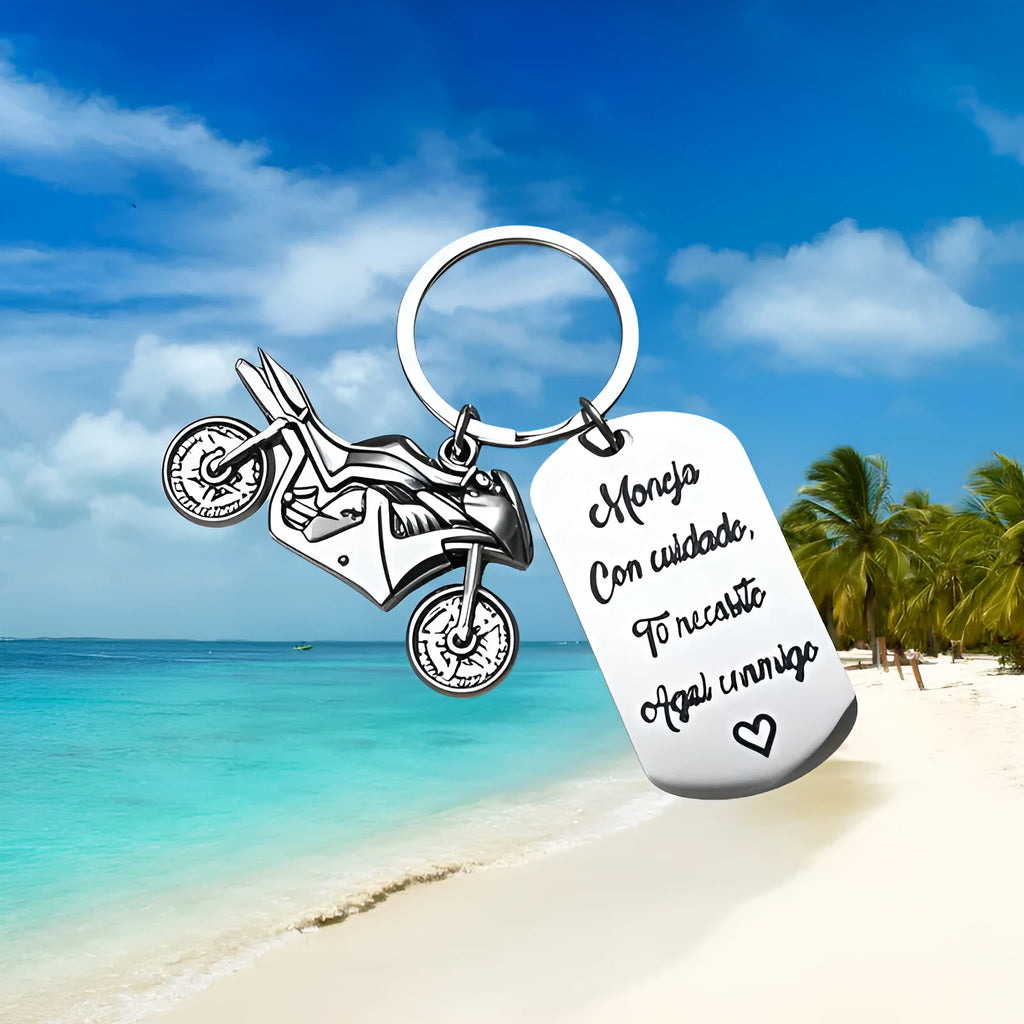 Stainless steel motorcycle-themed keychain with minimalist design, shown with its flannel storage bag.