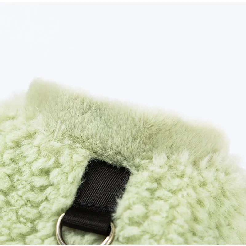 Two-legged sleeveless fleece dog vest with integrated leash ring in soft green or neutral beige, sizes XS to XL