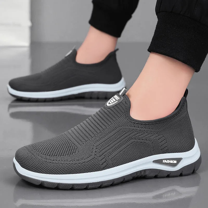 Men's black and grey casual tennis shoes with mesh lining and flat PVC sole.