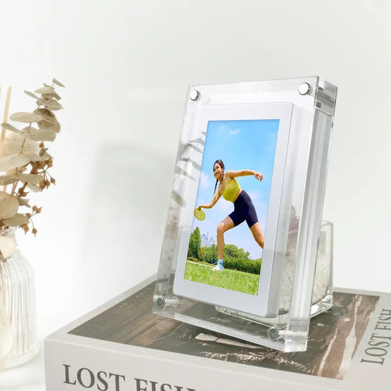 White vertical digital photo frame with 5-inch screen showing family photographs