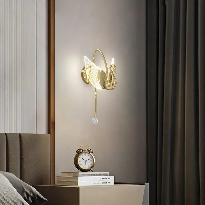 Gold-coloured modern swan-shaped wall lamp with acrylic shade and dimmable multi-colour LED light.