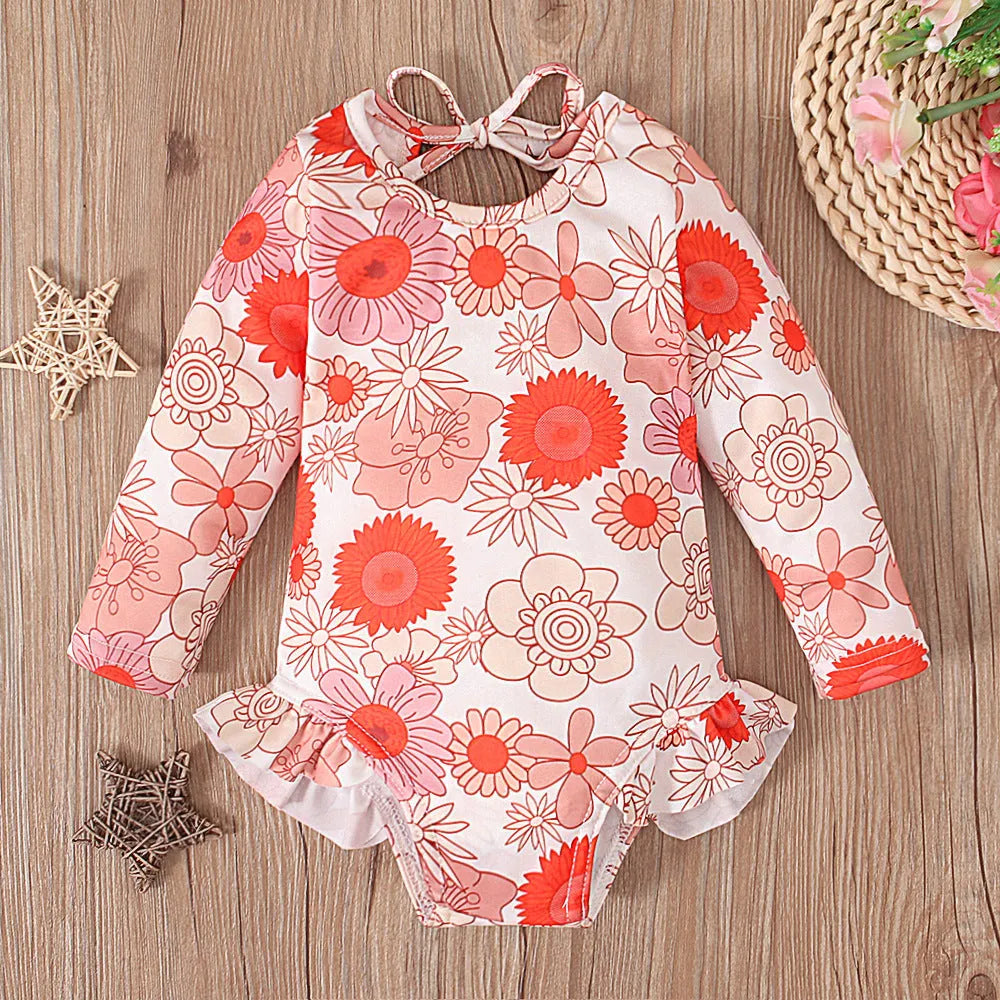 Girl's floral pattern swimsuit with crew neck and open back design in polyester fabric