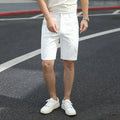 Man wearing loose-fit, mid-length casual trousers with an elastic waist in a solid colour.