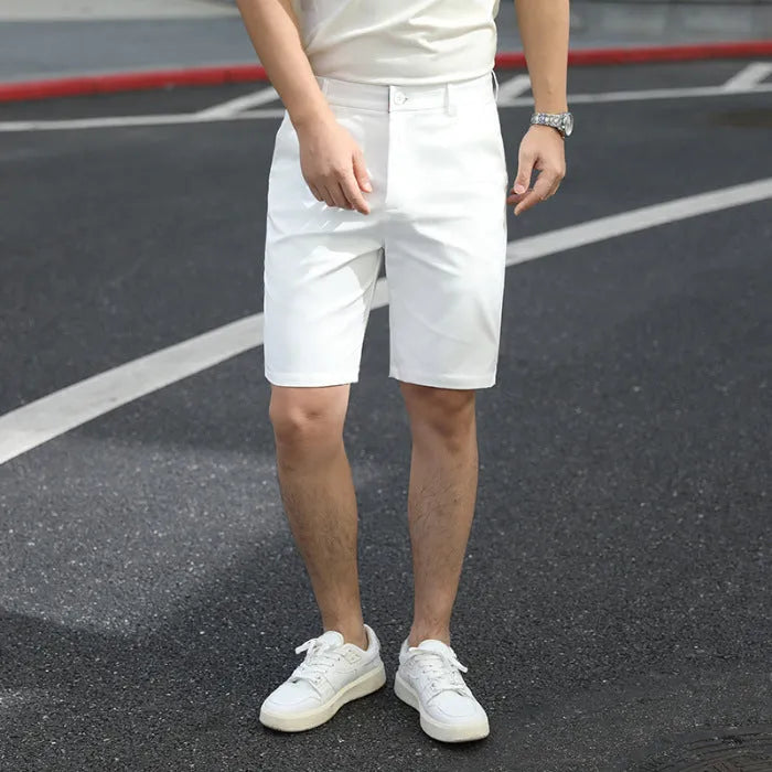 Man wearing loose-fit, mid-length casual trousers with an elastic waist in a solid colour.