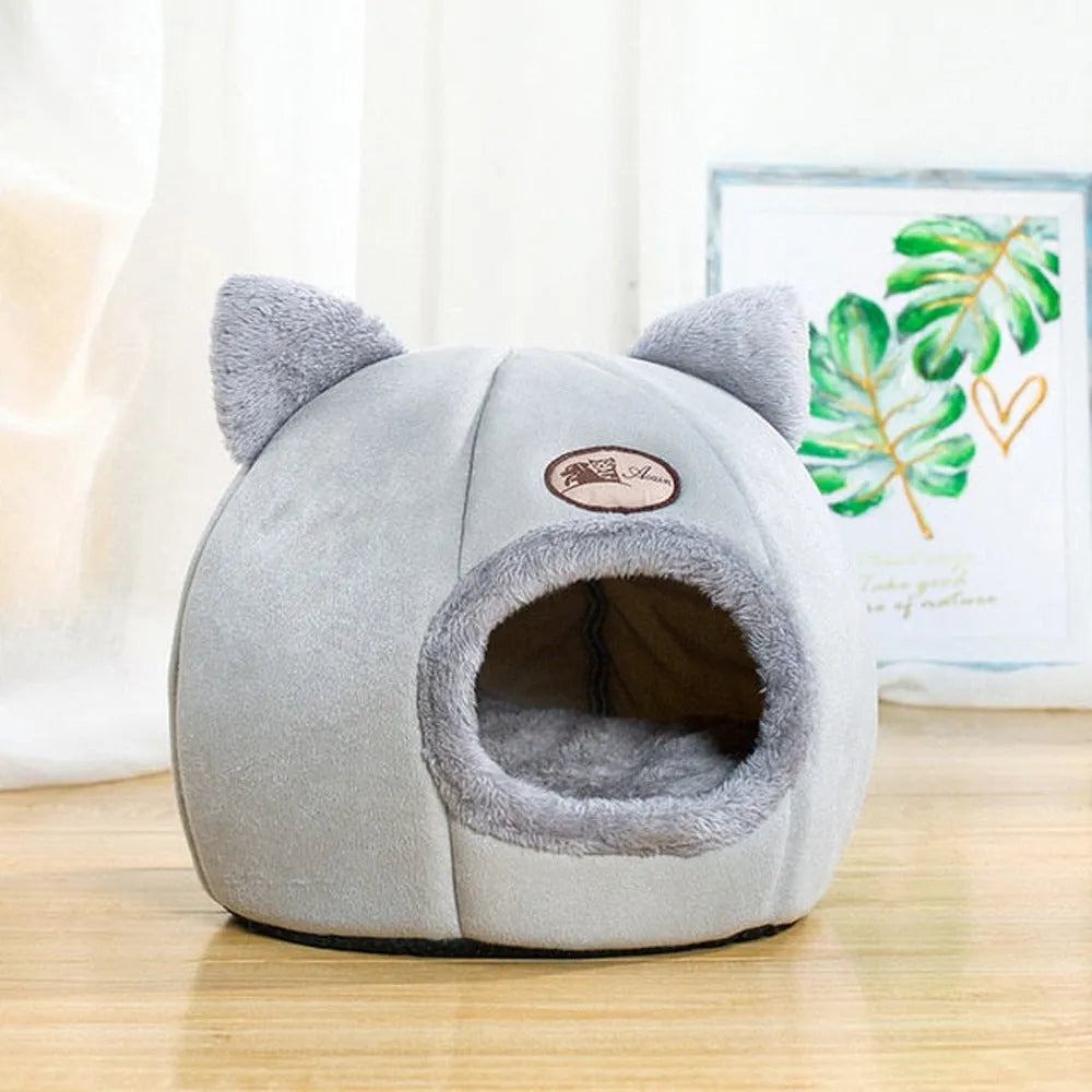 Fully enclosed plush cat winter nest sofa bed with removable cushion, shown in grey