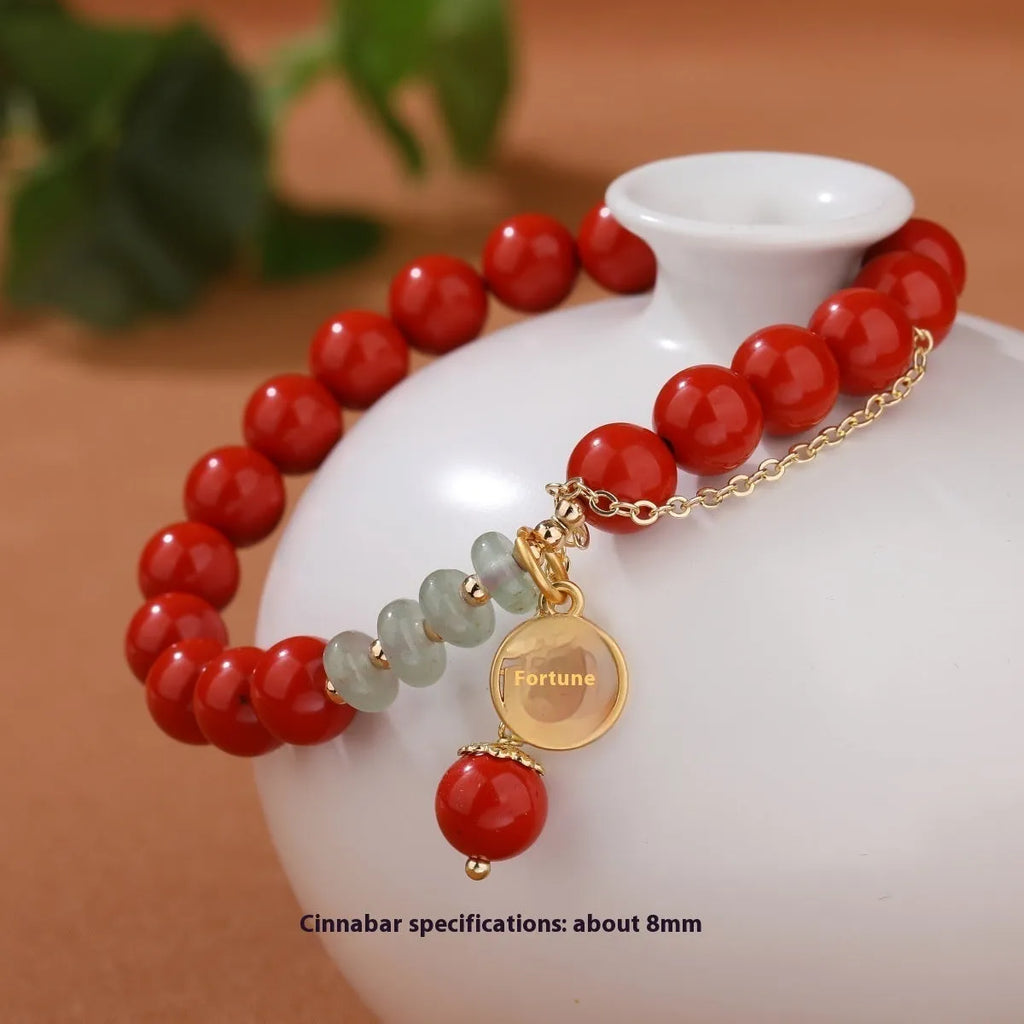 Retro women's bracelet with red sand cinnabar fu character pendant, jade spacer beads, and tassel detailing