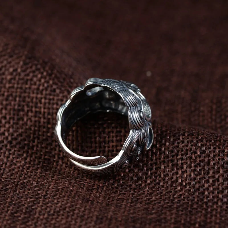 Silver open ring with detailed animal Jibeast pattern and geometric design