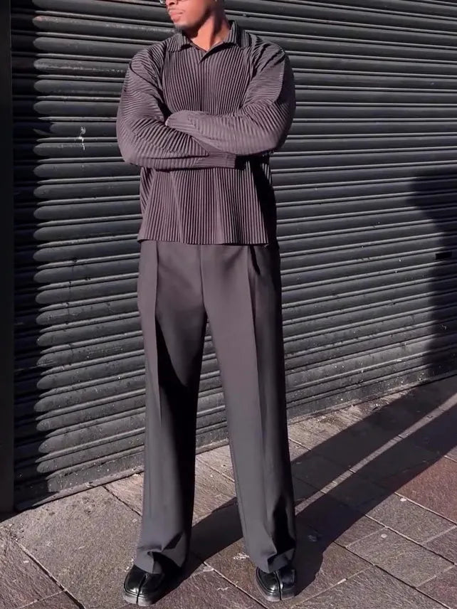Black men's pleated long-sleeved polyester top showing vertical texture detail