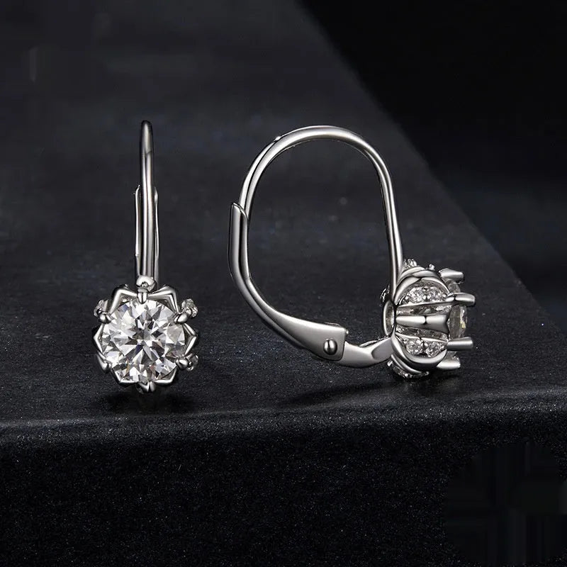 Sterling silver flower bud clip earring with moissanite stone and electroplated platinum finish.