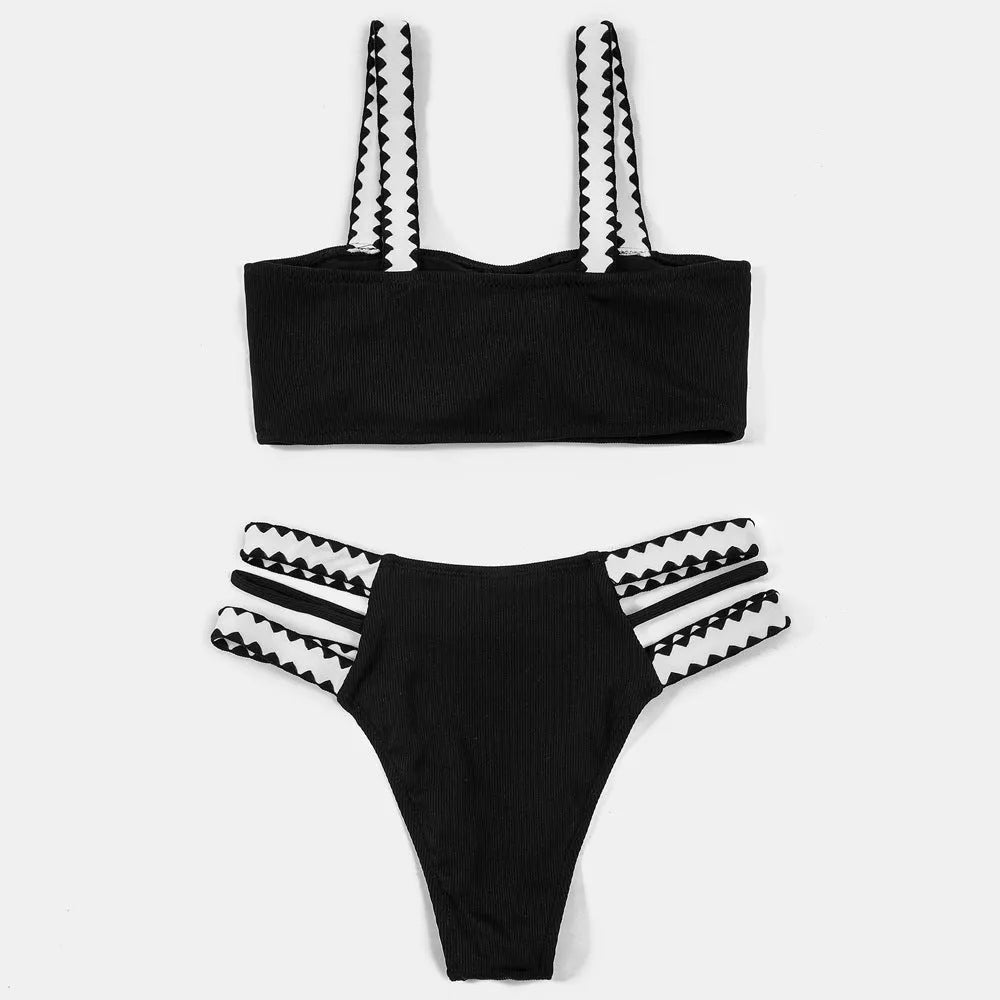 Black women's bikini swimsuit with a hollowed-out split design and brief style.
