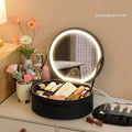 Round pink PU leather makeup bag with LED mirror open, showing internal partitions and carry strap.