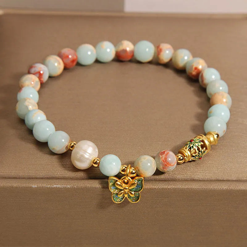 Blue freshwater pearl bracelet with Shoushan stone elements and butterfly pendant.