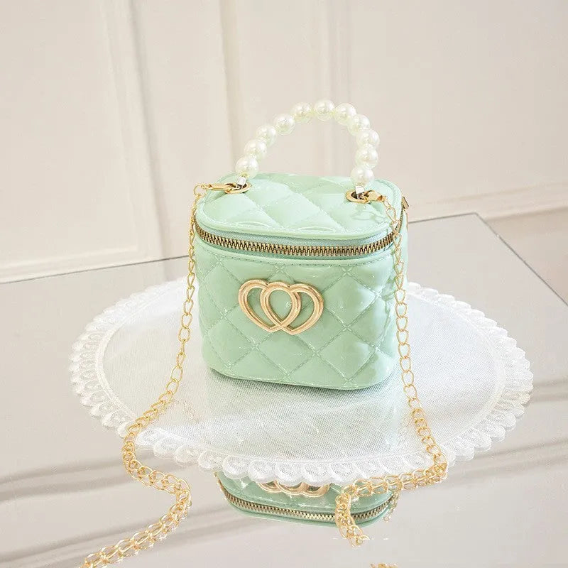 White PVC bucket bag with a red heart pattern, showing its shape and design.