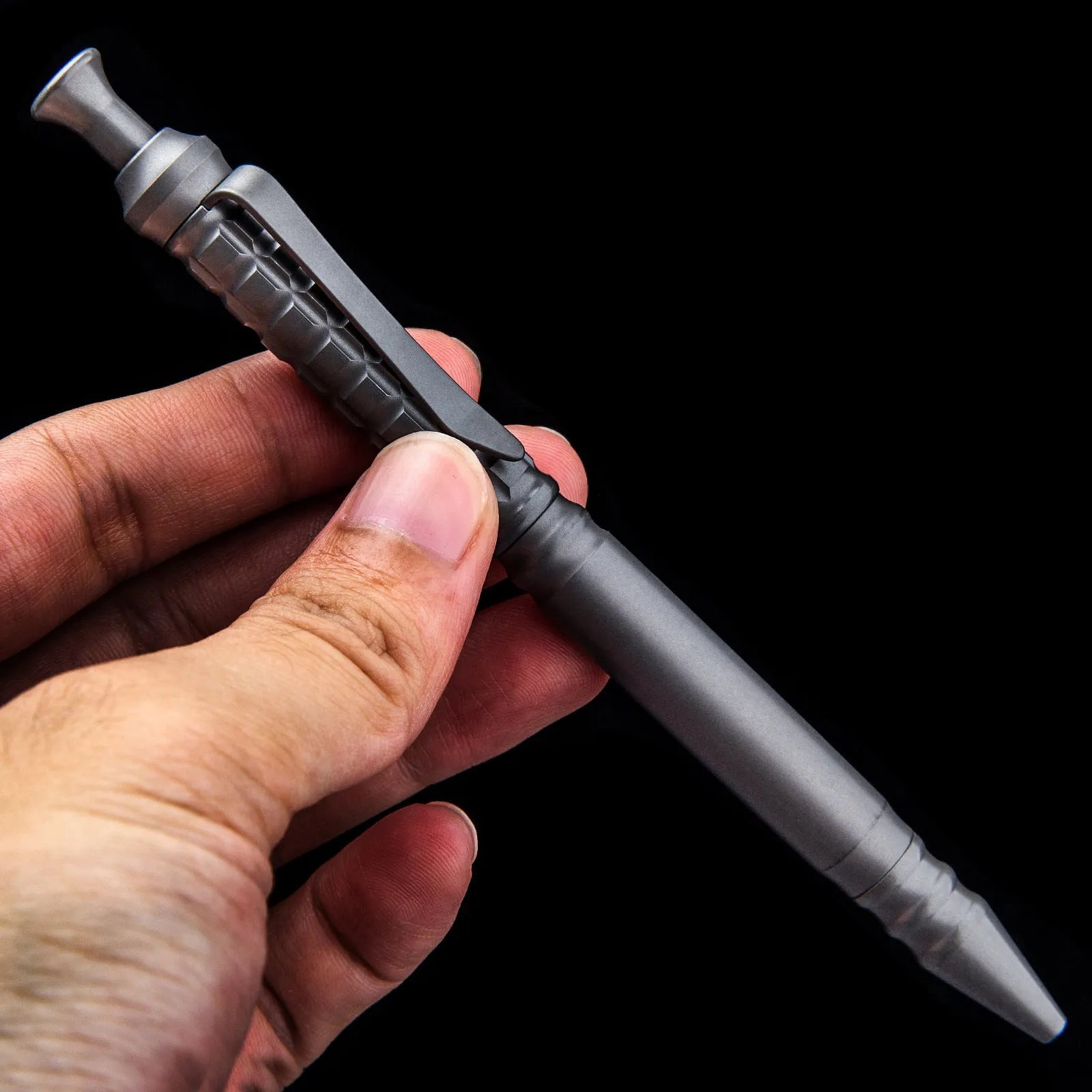 Gunmetal grey titanium tactical pen with push-action decompression mechanism