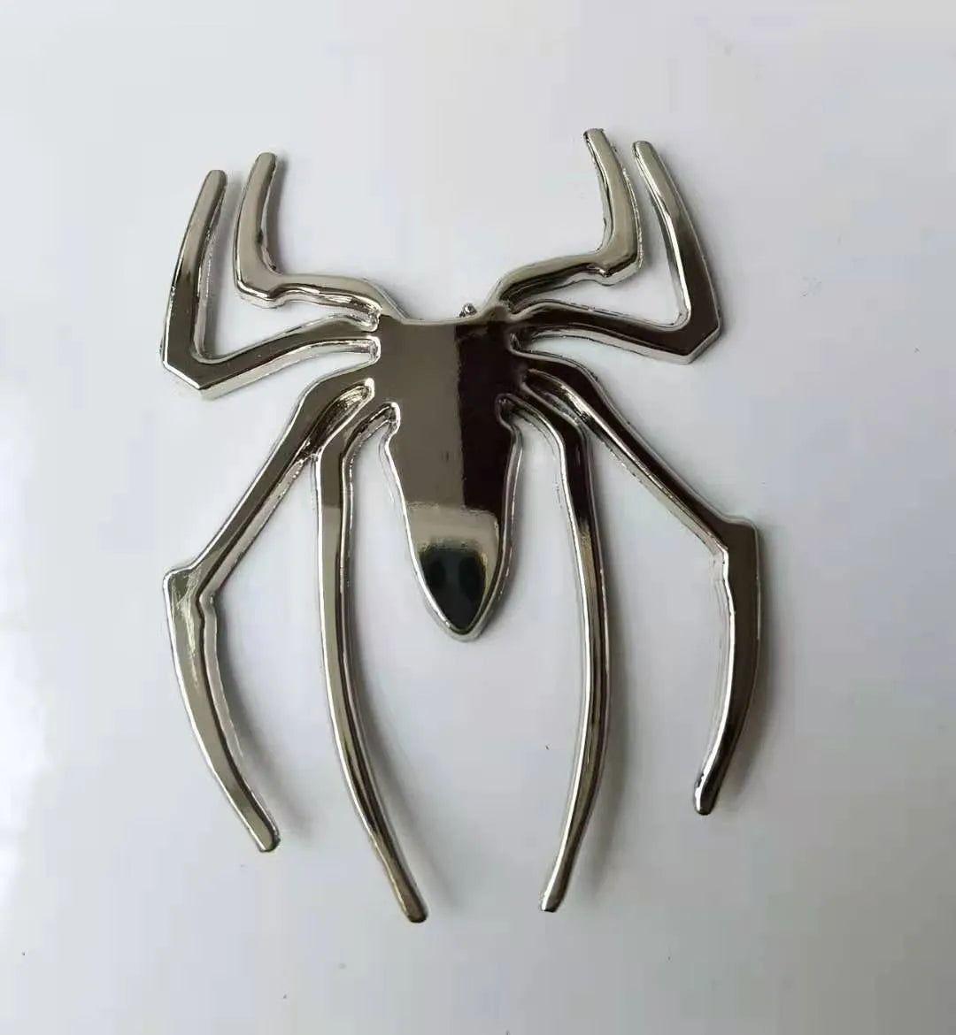 Three-dimensional metal spider car sticker in zinc alloy on a vehicle bumper.