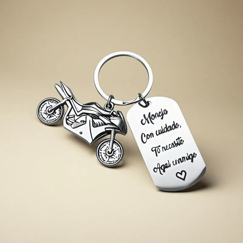 Stainless steel motorcycle-themed keychain with minimalist design, shown with its flannel storage bag.