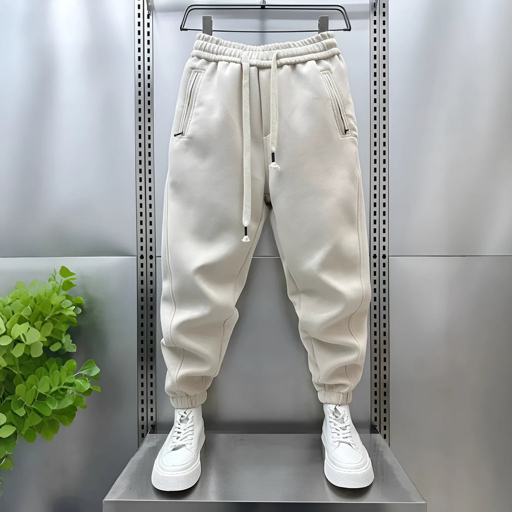 Summer men's solid colour polyester track sweatpants with zippered pockets and ankle ties, black, side view