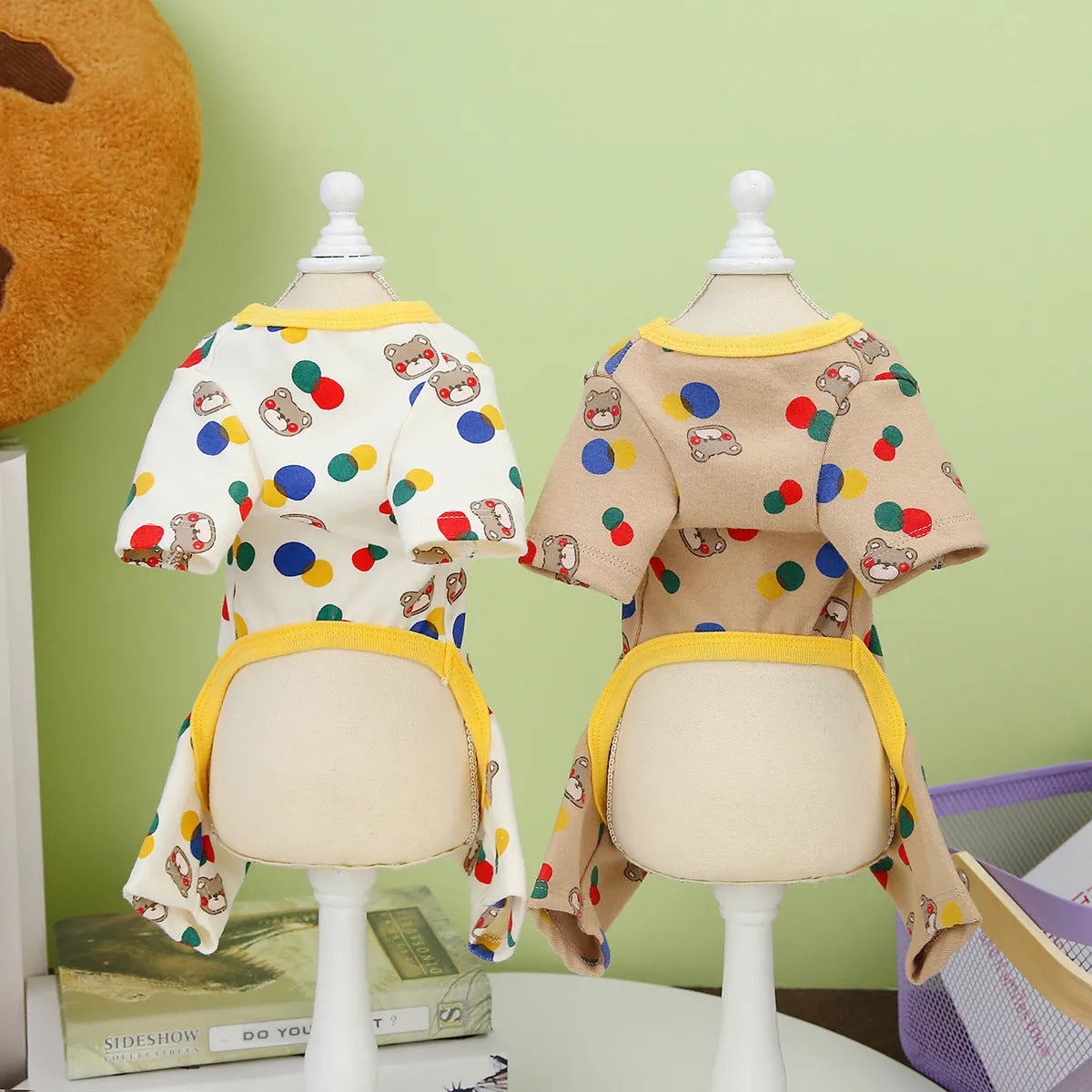 Beige dog t-shirt with a colourful cartoon ball bear design, showing a casual fit on a pet.
