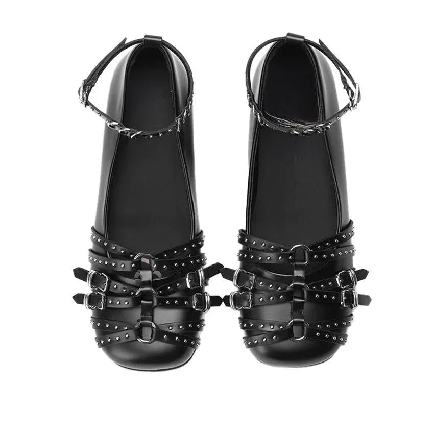 Women's black patent leather buckle pumps with a square toe and low flat heel on a white background.