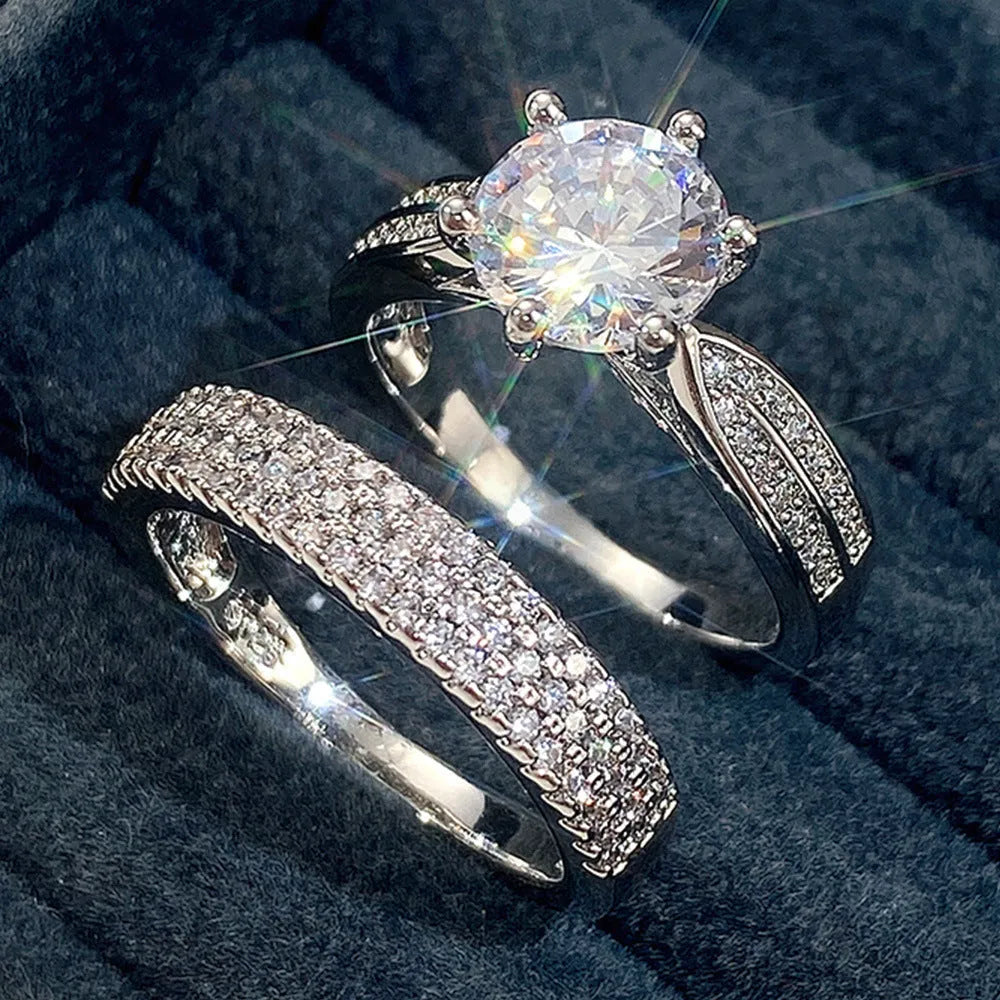 White gold colour alloy combined ring and bracelet with geometric shape and round details.