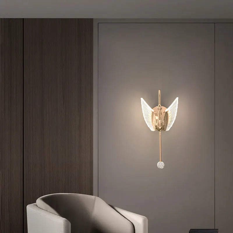 Gold-coloured modern swan-shaped wall lamp with acrylic shade and dimmable multi-colour LED light.