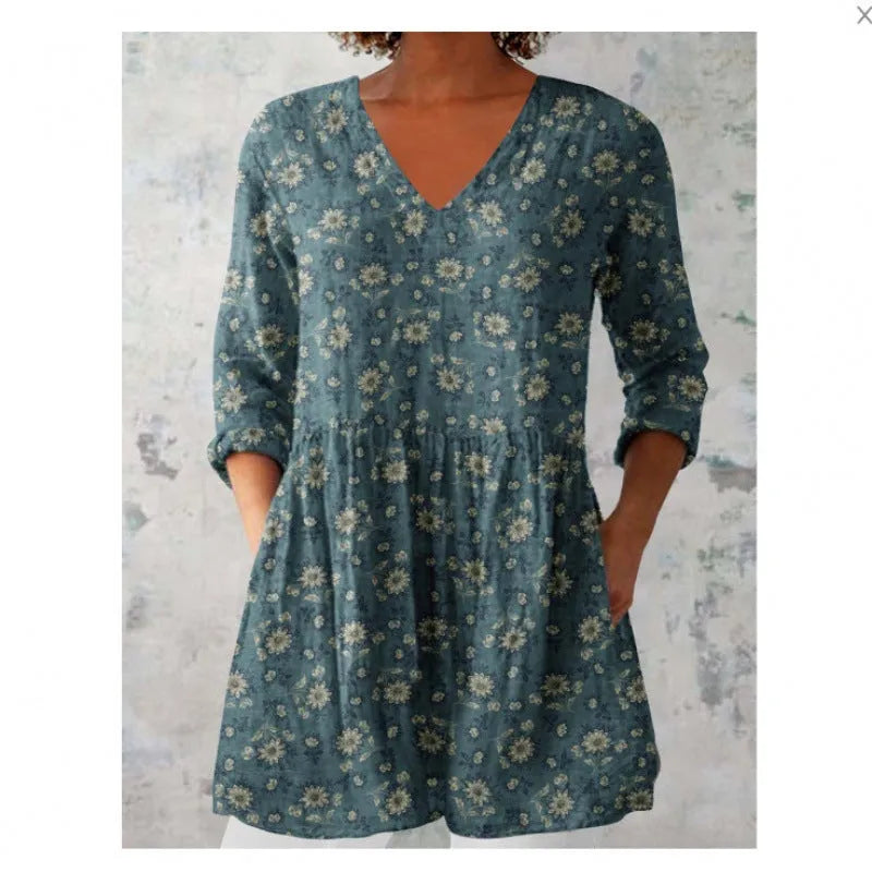 Women's loose-fitting dress with a blue wave print pattern, wide waist, and three-quarter length sleeves.