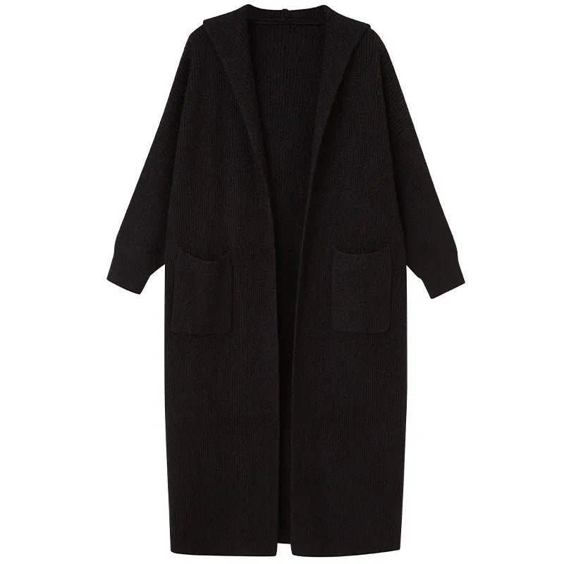 Long grey knitted cardigan with a hood, shown on a model, featuring a loose trench coat style.