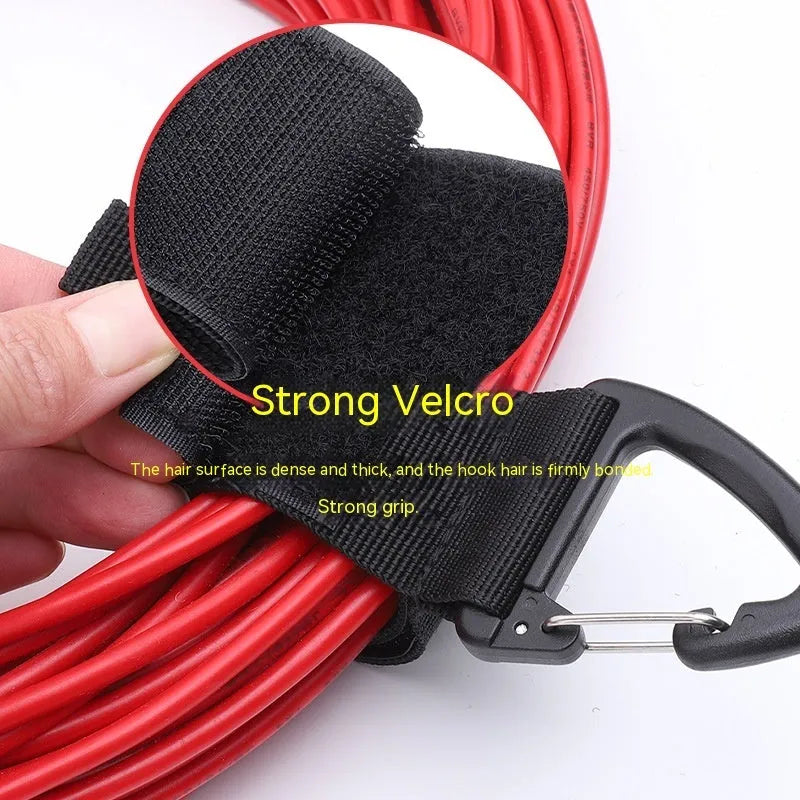 Black heavy-duty storage strap with carabiner hook and gravity strap climbing button for tool organisation