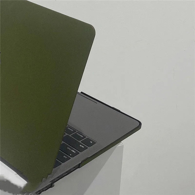Quicksand army green polycarbonate MacBook protective shell on a laptop showing textured finish.