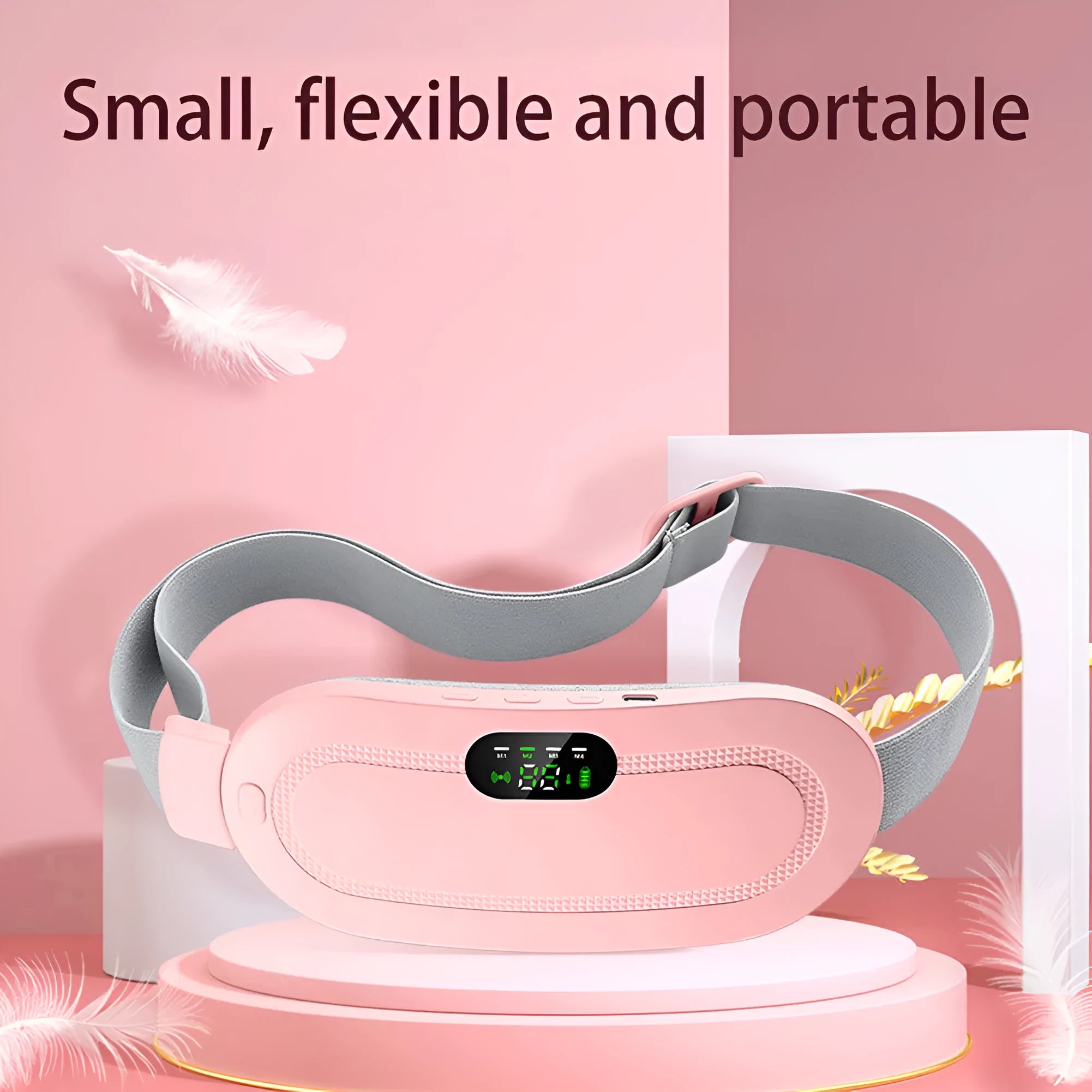 Pink and white menstrual heating belt with USB charger, controller, and long cable on a grey background.